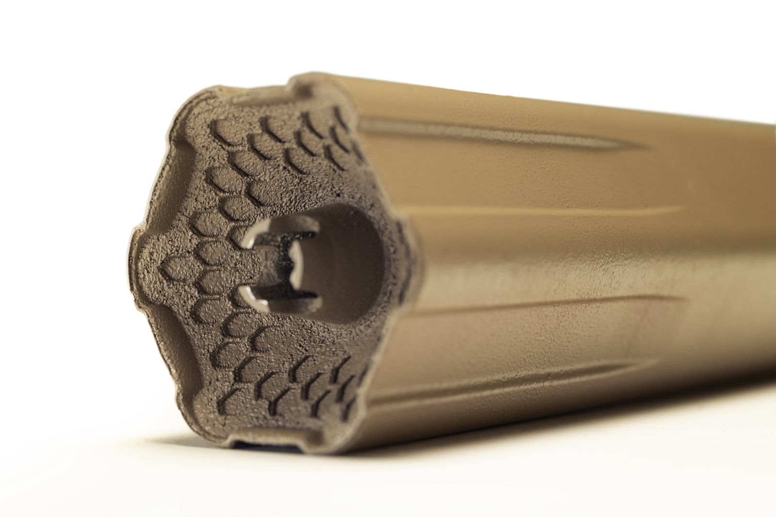 Big Sixy centerfire suppressor in FDE – close-up of hexagonal baffle face and muzzle end, Energetic Armament
