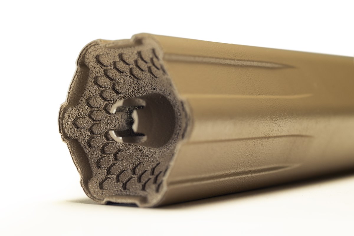 Big Sixy centerfire suppressor in FDE – close-up of hexagonal baffle face and muzzle end, Energetic Armament